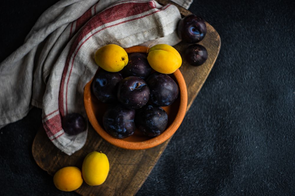 Ripe pitted fruits on cutting board