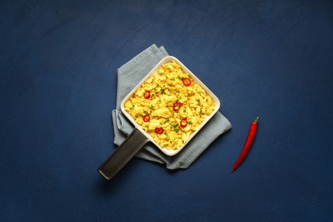 Scrambled eggs pan with chili peppers