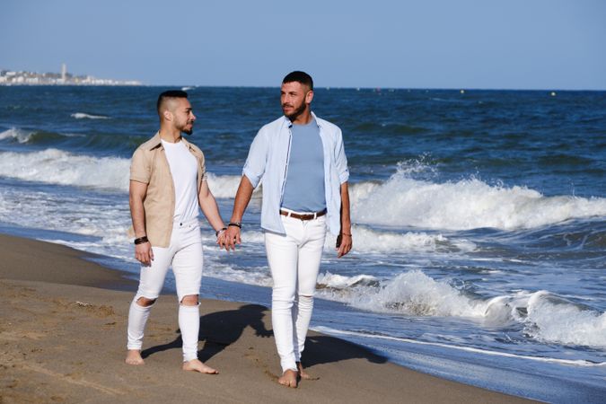 Gay couple walking on beach