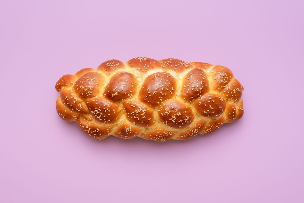 Challah bread above view, isolated on a purple background