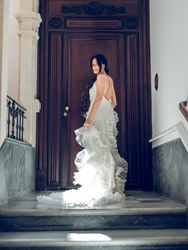Gorgeous bride in wedding dress near wooden door