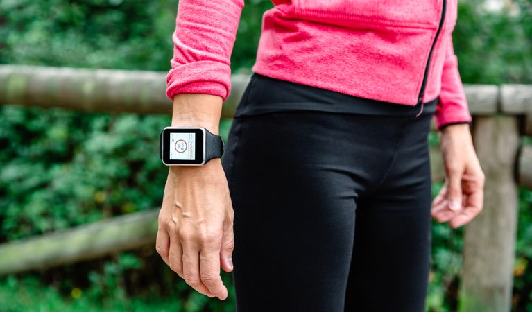 Unrecognizable female athlete with smartwatch