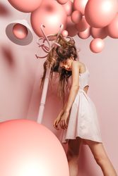 Woman with tangled hair in a pink room