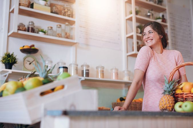 Portrait of beautiful young woman standing behind the counter of her juice bar