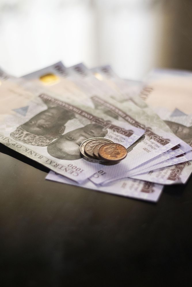Nigerian naira banknotes and coins on a table
