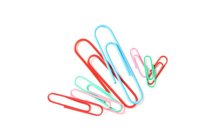 Color paper clips isolated on studio background, closeup