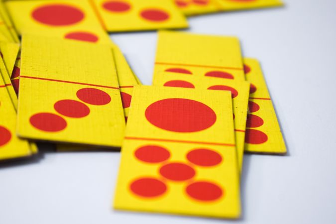 Close up of red and yellow domino playing cards on table