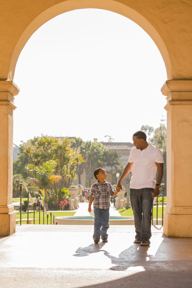 Father and Son Walking Through Arch in the Park