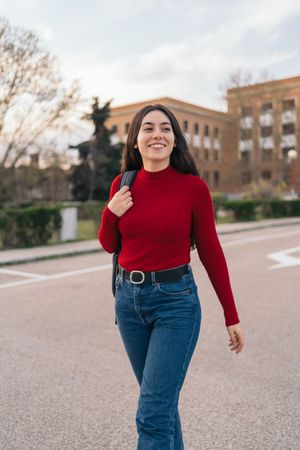 Student portrait leaving class and smiling, walking