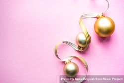 Gold Christmas baubles on pink background 4BA2k5