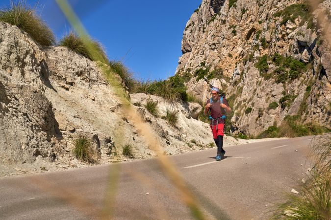Male explorer with backpack hiking in nature