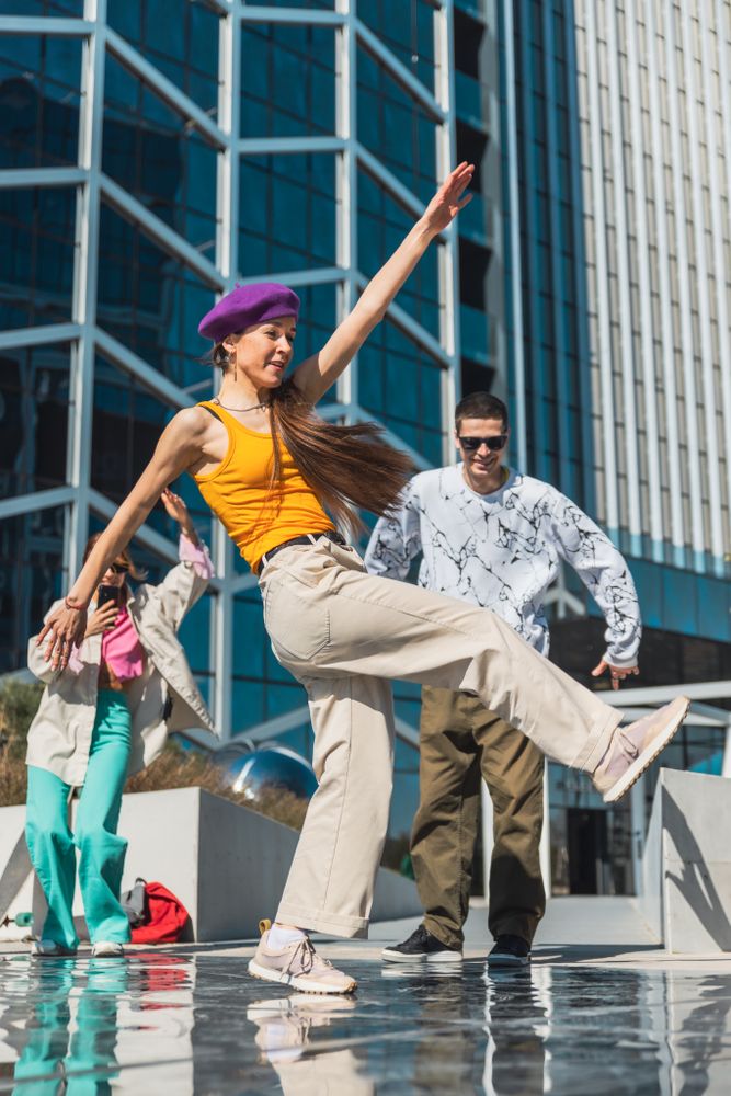 Vertical Screen: Young And Stylish Female Hip Hop Dancer Freestyling On City Street In the Circle Of Fashionable Friends.