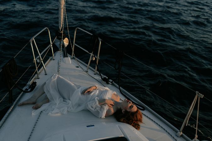 Woman in luxury dress resting on yacht