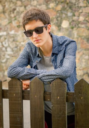 Hipster man  with sunglasses over a fence