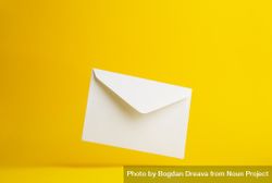 Diagonal floating envelope over light yellow background 0gzyeb