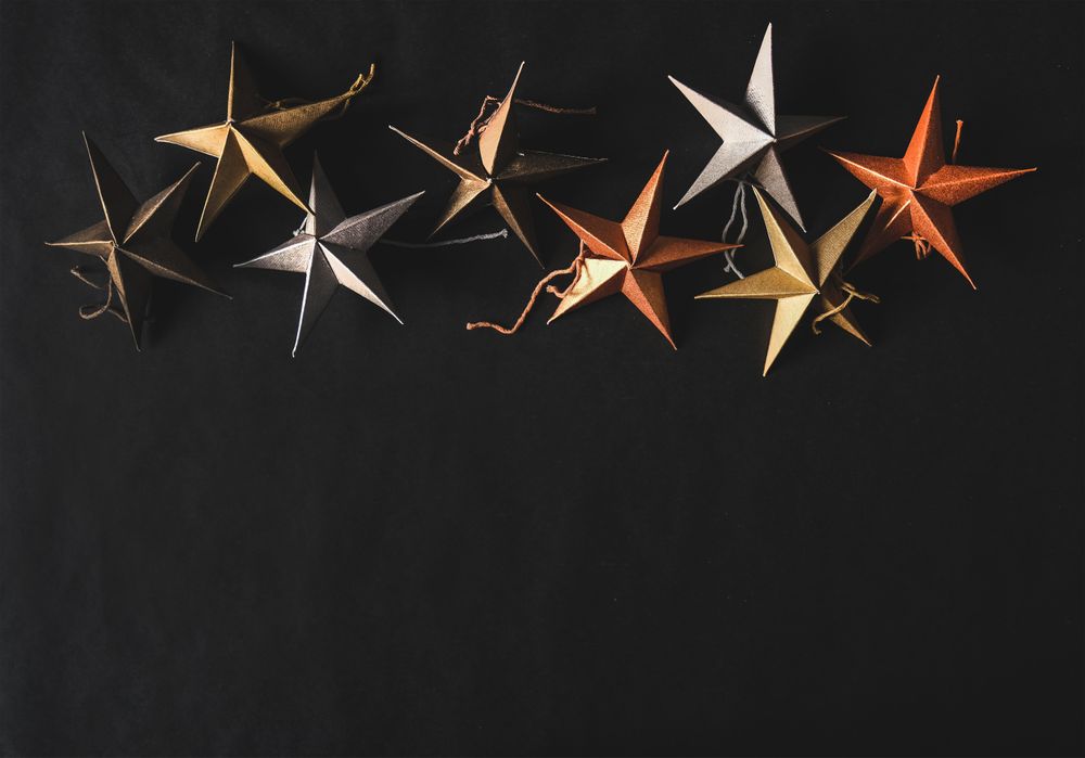 Flat-lay of colorful paper toy decorative stars, close together