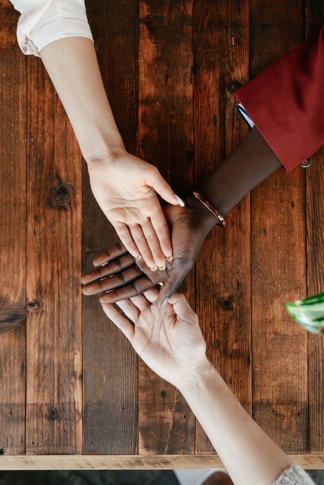 Cropped image of hands of different people on top of each other