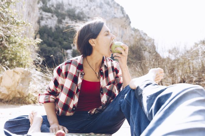 Couple spending picnic on shore in cliffs