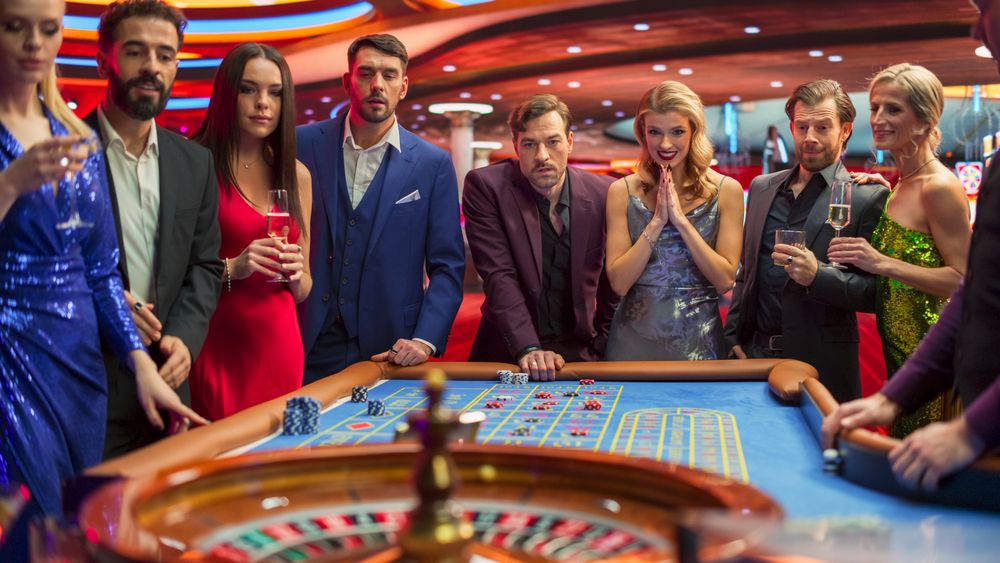 Casino Enthusiasts Making Calculated Bets at a Roulette Table.