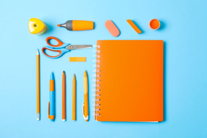 Flat lay composition with school supplies on color background, space for text