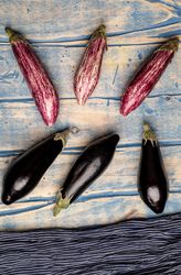 Ripe eggplants on shabby tabletop