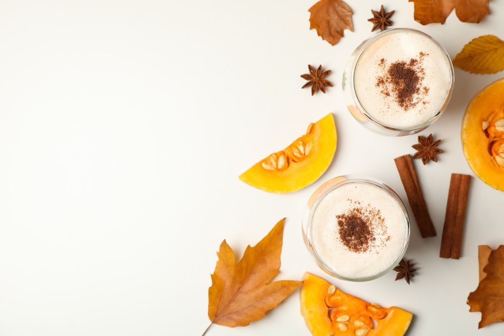 Composition with pumpkin latte on neutral background, top view
