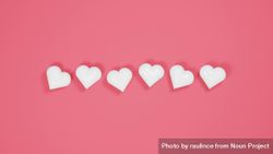 Plastic hearts on pink background 47aMB0