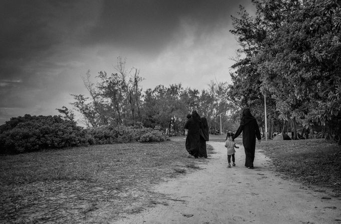 Women walking with daughter in a park, monochrome