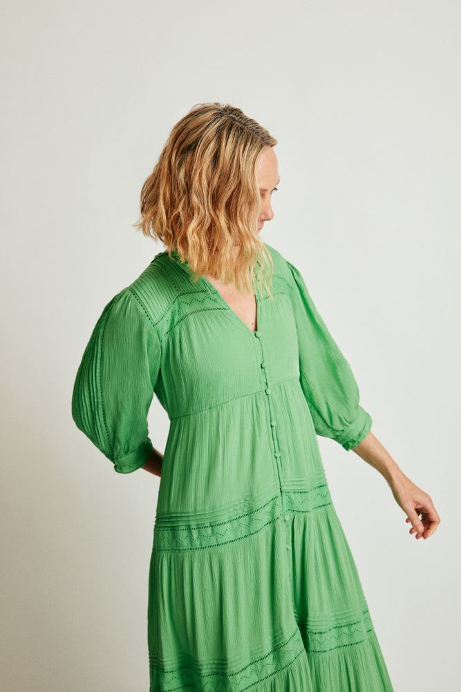 Woman with bob haircut standing in green dress
