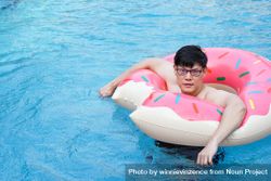Asian man with swim ring 5qAMo5