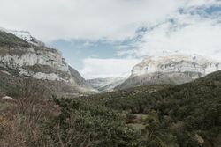 Wonderful valley with trees and high hills in cloudy weather