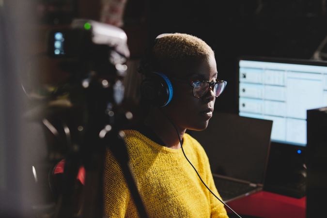 Black woman recording podcasts in radio studio