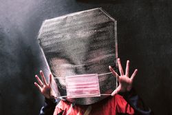 Person holding out a facemask
