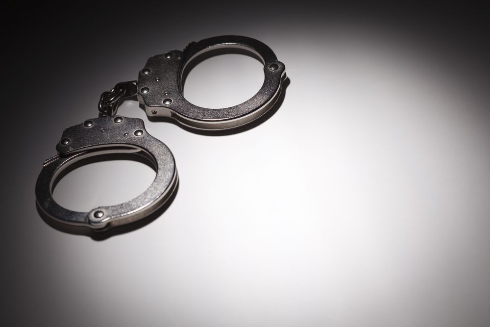 Abstract Pair of Handcuffs Under Spot Light - Text Room