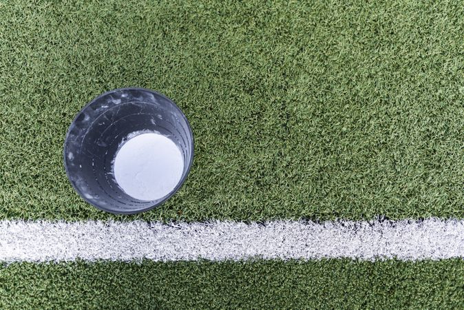 Bucket with chalk on lawn