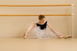 Ballet dancer performs a stretch in a dance studio