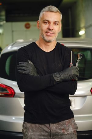 Confident mechanic in garage