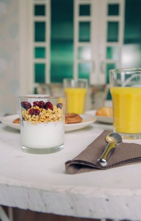 Yogurt parfait and orange juice on breakfast table