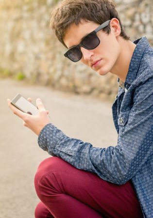 Man with sunglasses using a smart phone
