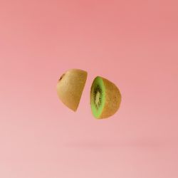 Kiwi halved on pastel pink background