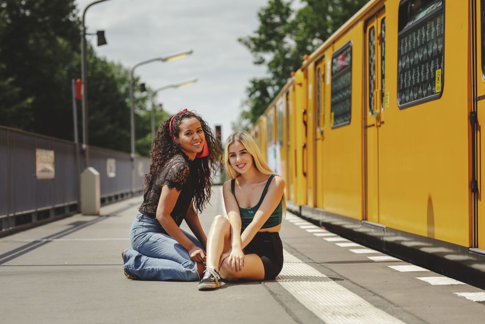 Friends sitting on train platform
