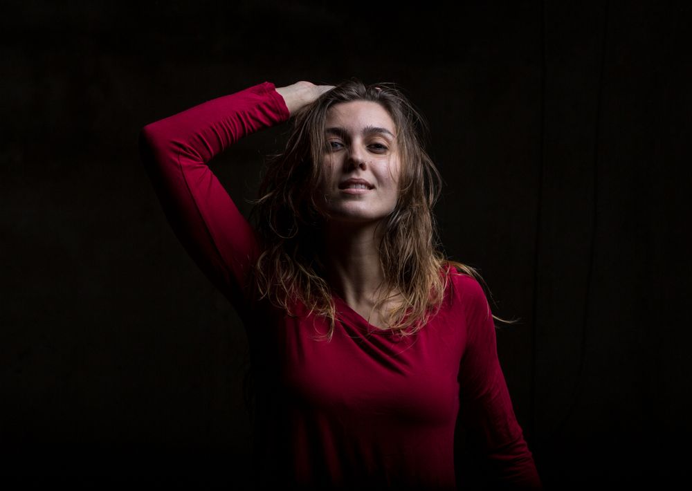 Young woman dancing in darkness