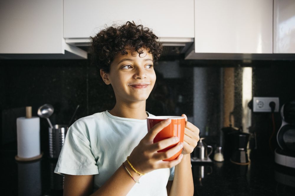 Girl drinking a cup of milk