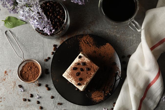 Composition with tasty tiramisu and lilac. Delicious dessert