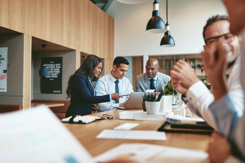 Group of people at open standing desk working on a project