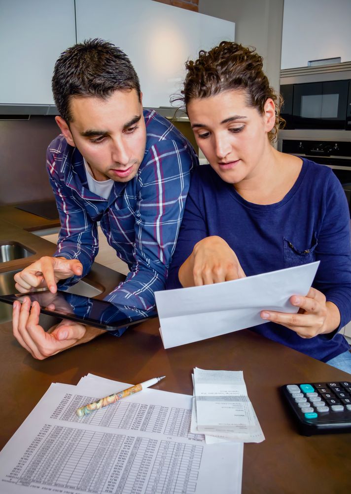 Woman showing man items on their monthly bills