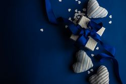 Top view of blue Valentine day concept with felt heart decoration, confetti and gift