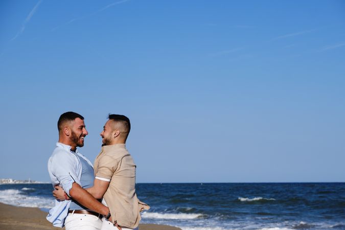 Happy gay couple enjoying and embracing outdoors