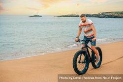 White male riding bicycle on beautiful coast 4d2JQ0