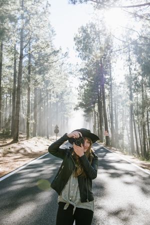 Woman with camera in forest